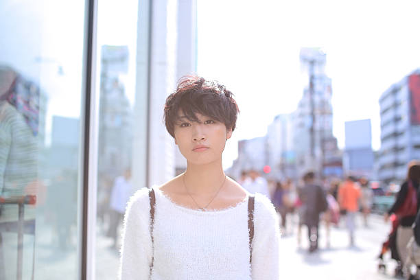 woman standing on the street - hairstyle stock-fotos und bilder