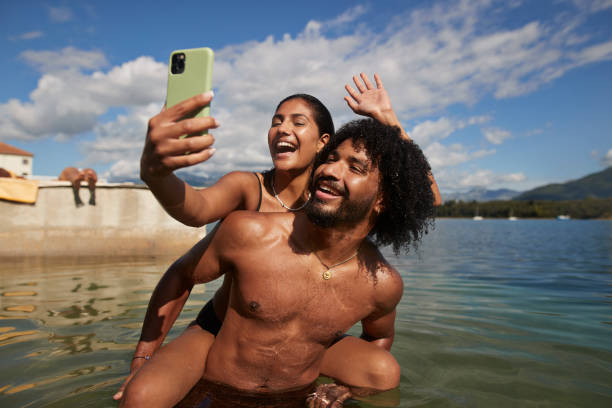 woman taking selfie with friend during vacation - travel stock pictures, royalty-free photos & images
