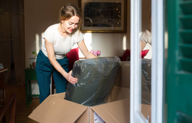 woman unpacking a new piece of furniture - home decoration stock pictures, royalty-free photos & images