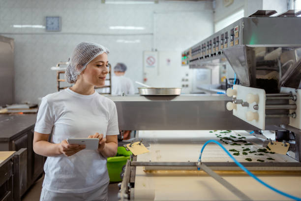 woman using a digital tablet to manage her bakery - food stock pictures, royalty-free photos & images