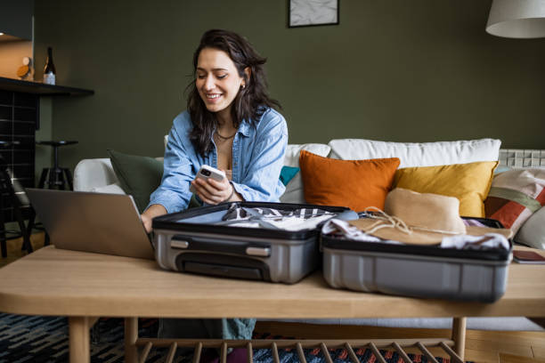 woman using laptop to book travel reservation - travel stock pictures, royalty-free photos & images