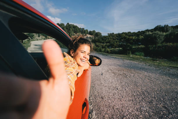 woman video bloger traveling by electric car with a smart phone, recording video stories for social media - travel stock pictures, royalty-free photos & images