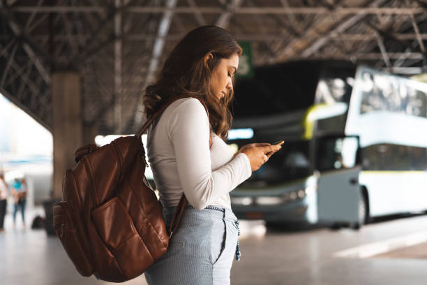 woman waiting for bus at the bus station - travel stock pictures, royalty-free photos & images