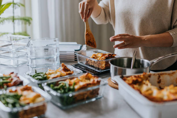 woman weighing lunch boxes as part of healthy meal prep - food stock pictures, royalty-free photos & images