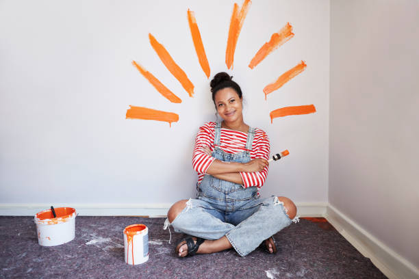 woman with brush strokes on wall renovating home - home decoration stock pictures, royalty-free photos & images