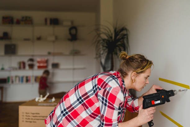 woman with electric drill - home decoration stock pictures, royalty-free photos & images