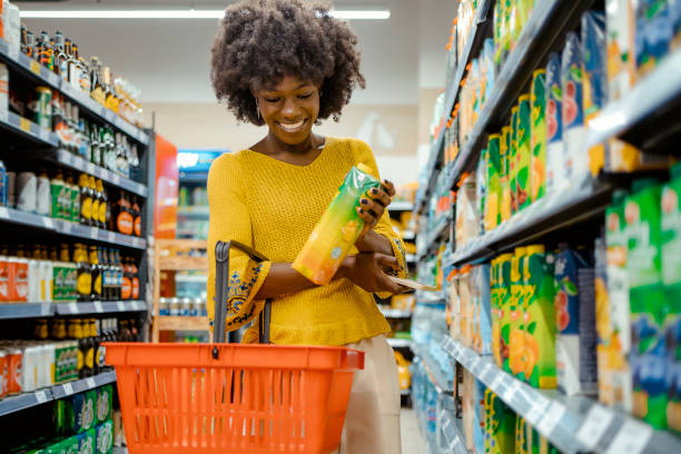 woman with food basket at grocery store - food stock pictures, royalty-free photos & images