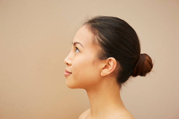 woman with hair bun - hairstyle fotografías e imágenes de stock