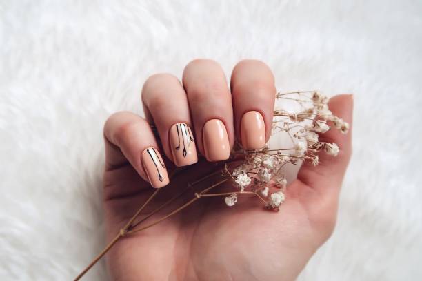 woman with nail art holding flower - nails art stock pictures, royalty-free photos & images