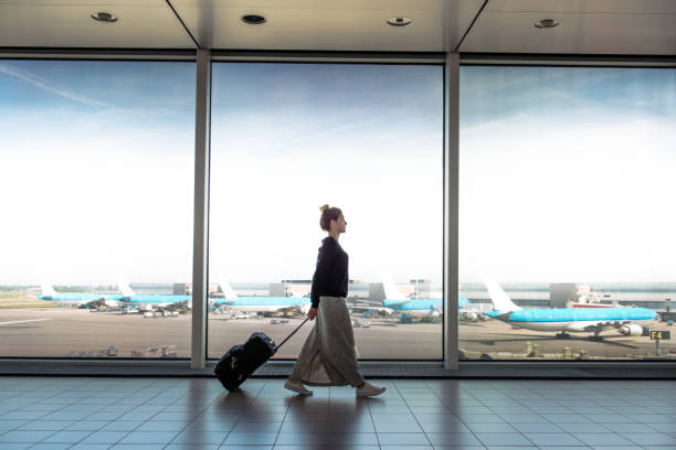 woman with suitcase is going to board on the next flight - travel stock pictures, royalty-free photos & images
