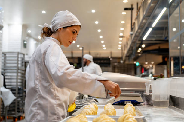 woman working at a bakery making croissants - food stock pictures, royalty-free photos & images