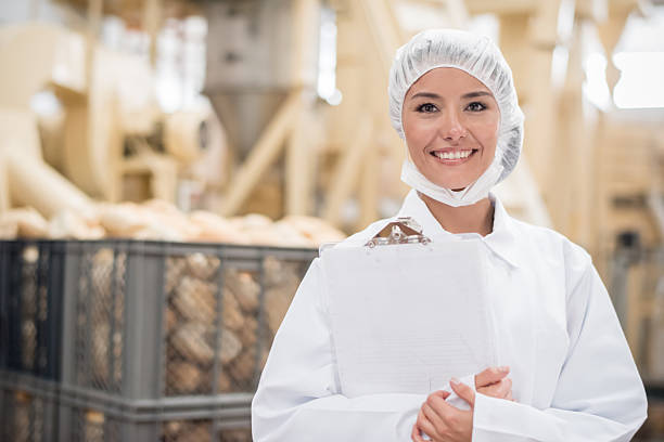 woman working at a bread factory - food stock pictures, royalty-free photos & images