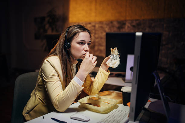 woman working late in call center - junk food stock pictures, royalty-free photos & images