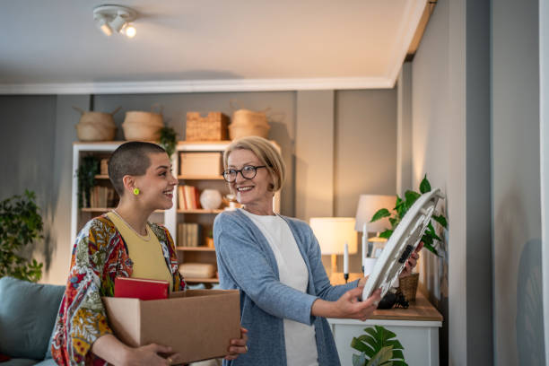 women unpacking and decorating new home together after moving in - home decoration stock pictures, royalty-free photos & images