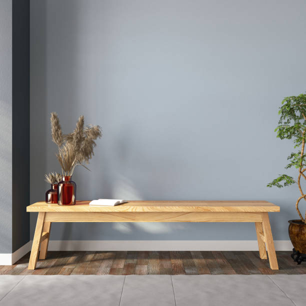 wooden bench with a book ,dried flowers and empty wall - home decoration stockfoto's en -beelden