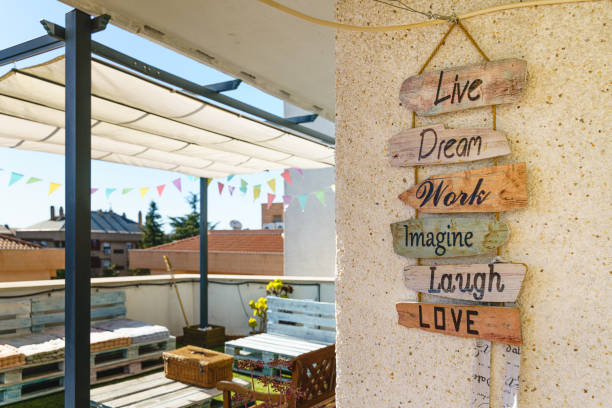wooden decoration sign with positive emotions at sunny home terrace - garden decoration stock pictures, royalty-free photos & images