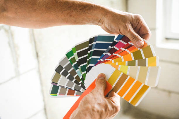 worker doing renovations in an apartment, color swatch, - home decoration stock pictures, royalty-free photos & images