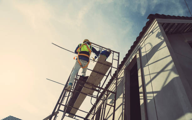 workers, contractors, engineers in plaid shirts and yellow hard hats carry toolboxes. inside the house that is being constructed, renovated, renovated by a professional technician who is ready to repair and improve and build