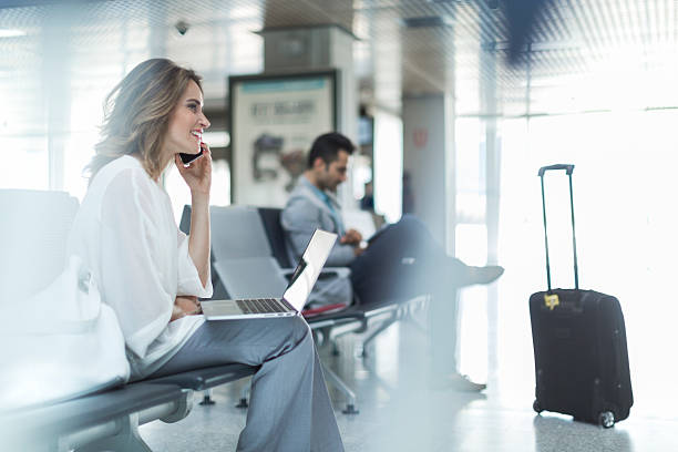 working and using phone while waiting on departure gate. - travel stock pictures, royalty-free photos & images