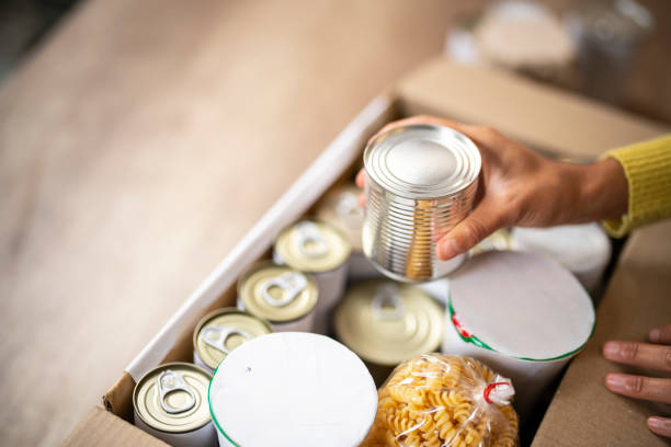 working at charitable foundation, packing donation box - food stock pictures, royalty-free photos & images