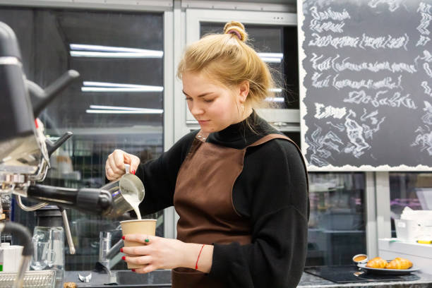 working in a cafe at night - young waitress preparing coffee in the cafeteria - junk food stock pictures, royalty-free photos & images