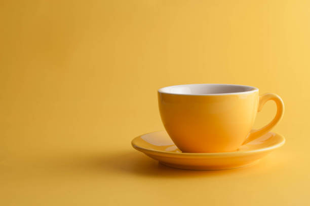 yellow coffee cup on a yellow background - coffee stock pictures, royalty-free photos & images