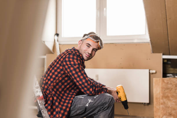yooung man renovating his new home, holding electric drill - home decoration stock pictures, royalty-free photos & images
