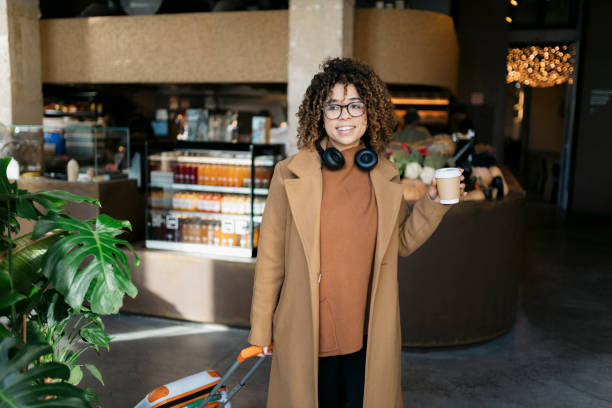 young adult woman enjoying coffee while shopping - junk food stock pictures, royalty-free photos & images