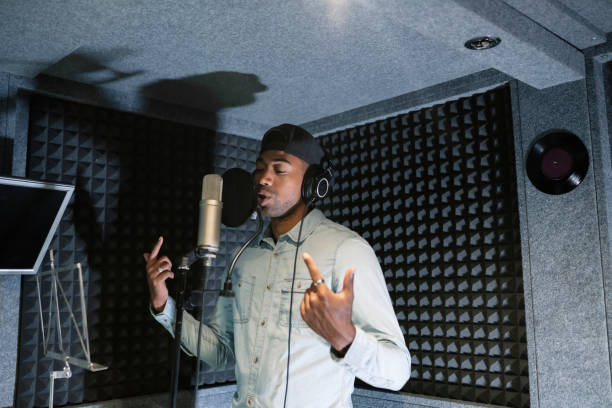 young african american male rapper, songwriter recording song in studio - concert stock pictures, royalty-free photos & images