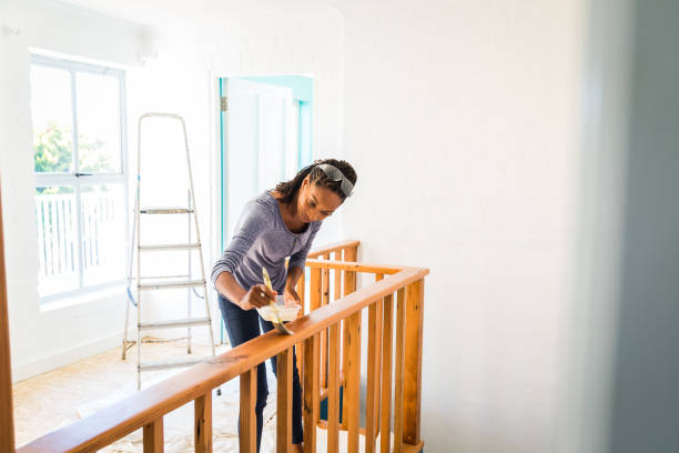 young afro-caribean woman renovating her home - home decoration stock pictures, royalty-free photos & images