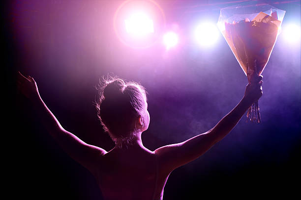 young artist girl greeting her public after performance on stage - concert stock pictures, royalty-free photos & images