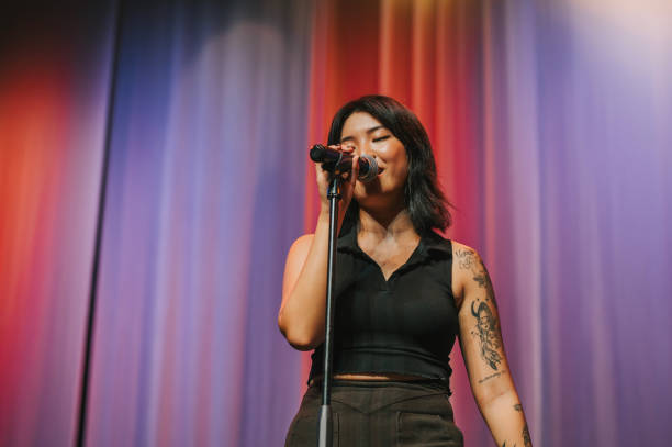 young asian chinese solo female singer singing performance on stage - concert stock pictures, royalty-free photos & images