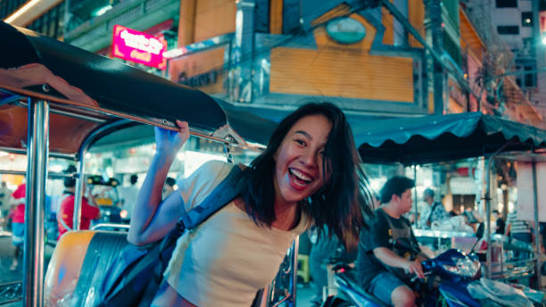 young asian woman tourist traveling by a tuk tuk vehicle on the street at bangkok, thailand. holiday vacation trip. - travel stock pictures, royalty-free photos & images
