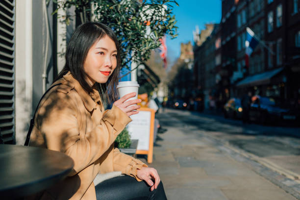 young beautiful woman drinking coffee at outdoor cafe - junk food stock pictures, royalty-free photos & images