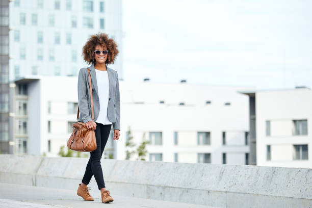 young businesswoman walking in city - fashion stock pictures, royalty-free photos & images