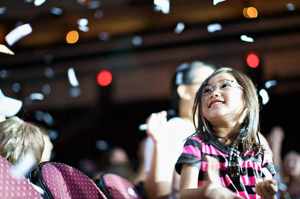 young child enjoying a concert with confetti - concert stock pictures, royalty-free photos & images