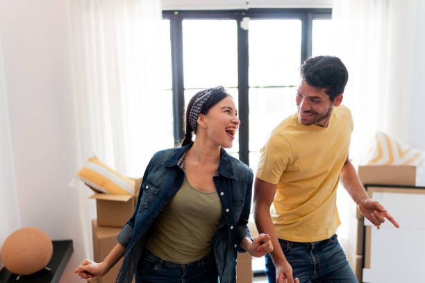 young couple dancing at the new home - home decoration stock pictures, royalty-free photos & images