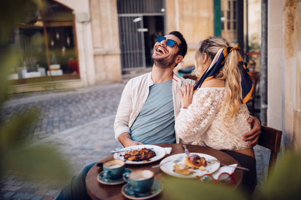 young couple drinking coffee and having fun at coffee shop - food stock pictures, royalty-free photos & images