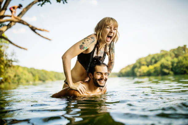 young couple having fun at the lake - travel stock pictures, royalty-free photos & images