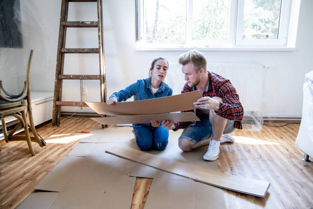 young couple improving their home. - home decoration stock pictures, royalty-free photos & images