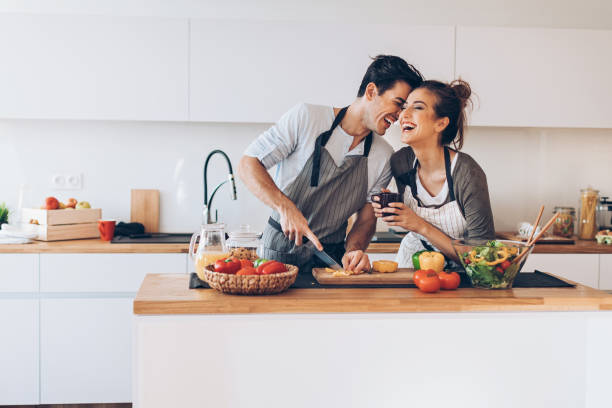 young couple in love in the kitchen - food stock pictures, royalty-free photos & images