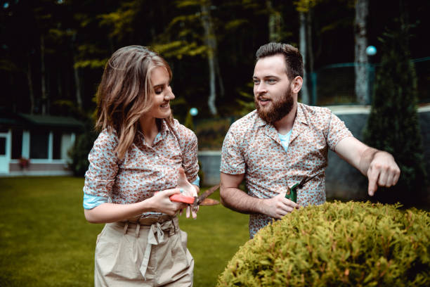 young couple learning about horticulture - garden decoration stock pictures, royalty-free photos & images
