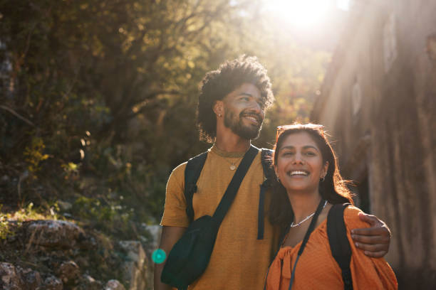 young couple looking away on sunny day - travel stock-fotos und bilder