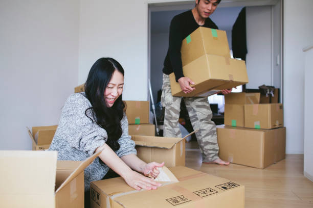 young couple unboxing boxes in their new house - home decoration stock pictures, royalty-free photos & images