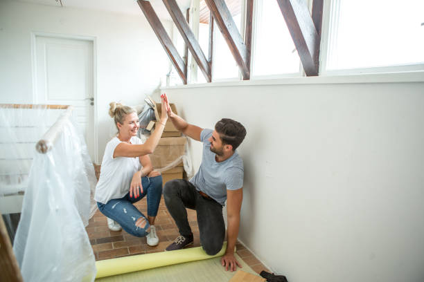young family renewing their house. - home decoration stock pictures, royalty-free photos & images