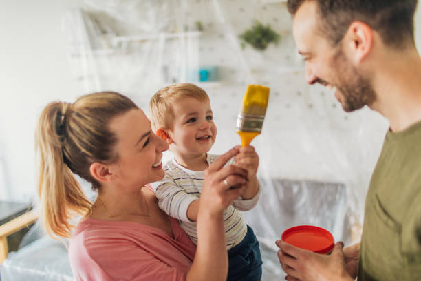 young family repainting their home - home decoration stock pictures, royalty-free photos & images