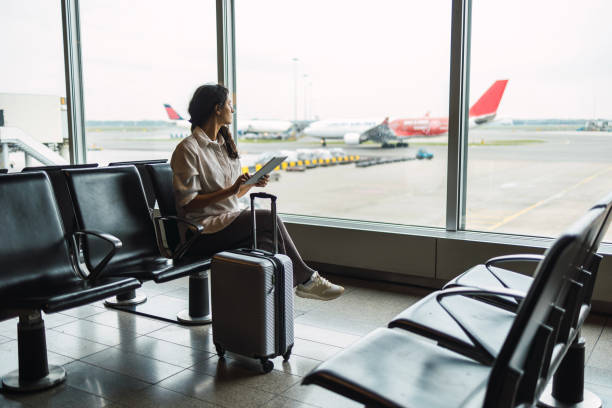 young female passenger waiting for flight at airport lounge - travel stock pictures, royalty-free photos & images