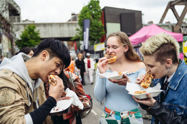 young friends enjoying east end street food for lunch - food stock pictures, royalty-free photos & images