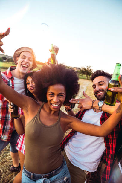 young friends enjoying the freedom on a car trip over a country offroad - concert stock pictures, royalty-free photos & images