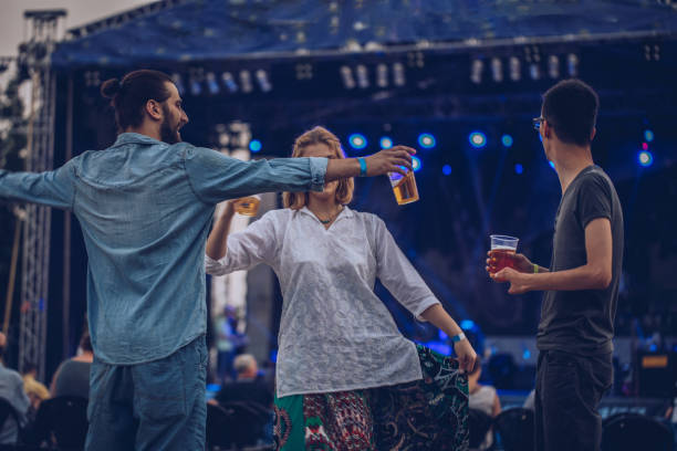 young friends having fun at music festival - concert stock pictures, royalty-free photos & images